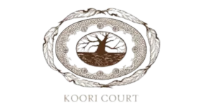 A stylized Aboriginal tree emblem surrounded by traditional patterns and feathers, with the text “KOORI COURT.”